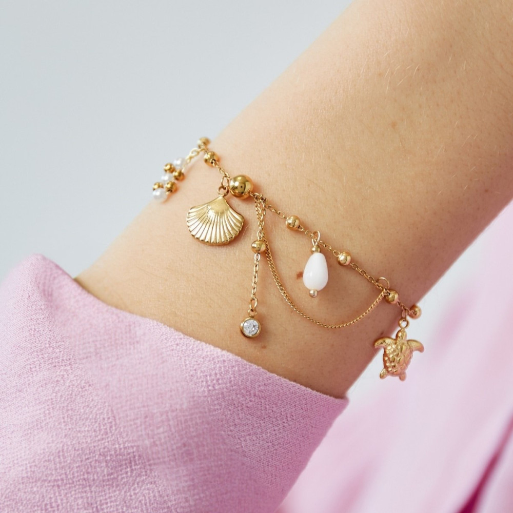 Bracelet doré avec perles et breloques plage